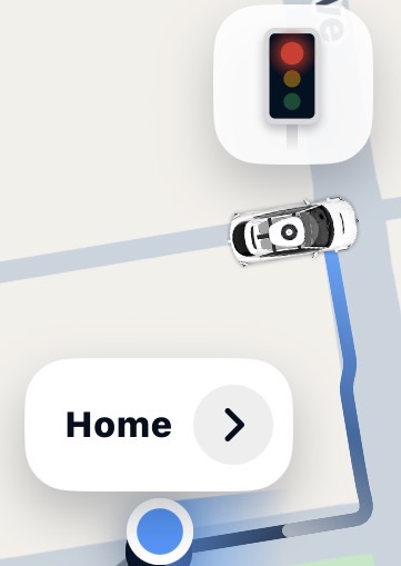 A map route with a car waiting at a traffic light